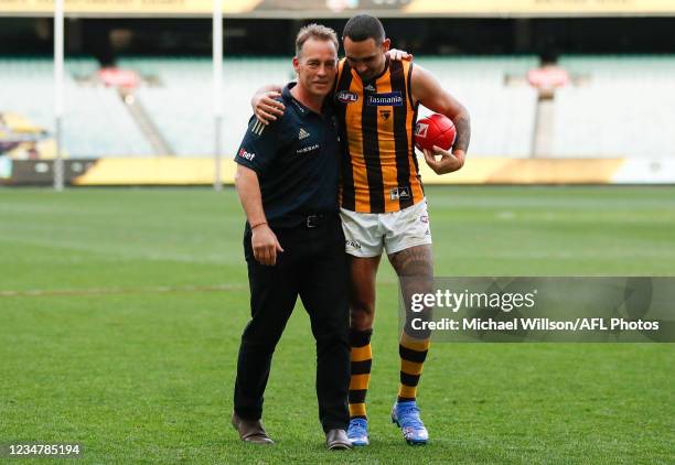 Alastair Clarkson, Senior Coach of the Hawks and Shaun Burgoyne of the Hawks leave the field for the last time during the 2021 AFL Round 23 match...