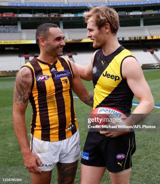 Shaun Burgoyne of the Hawks and David Astbury of the Tigers embrace after the 2021 AFL Round 23 match between the Richmond Tigers and the Hawthorn...