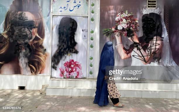 Women posters on beauty salon windows remain vandalized in Kabul, Afghanistan on August 20, 2021.