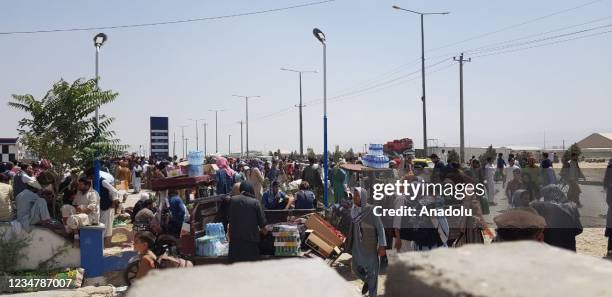 Afghans continue to wait around the Hamid Karzai International Airport as they try to leave the Afghan capital of Kabul, Afghanistan on August 21,...