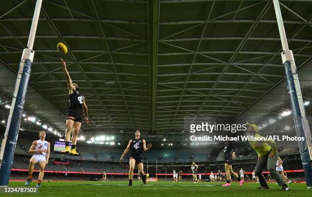 Adam Saad of the Blues attempts to touch the ball on the line during the 2021 AFL Round 23 match between the Carlton Blues and the GWS Giants at...