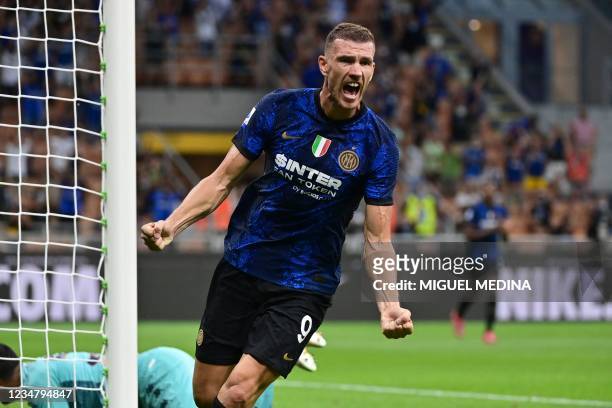 Inter Milan's Bosnian forward Edin Dzeko celebrates after he scored a goal during the Italian Serie A football match Inter Milan vs Genoa at San Siro...