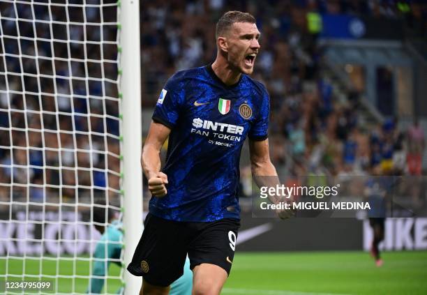 Inter Milan's Bosnian forward Edin Dzeko celebrates after he scored a goal during the Italian Serie A football match Inter Milan vs Genoa at San Siro...