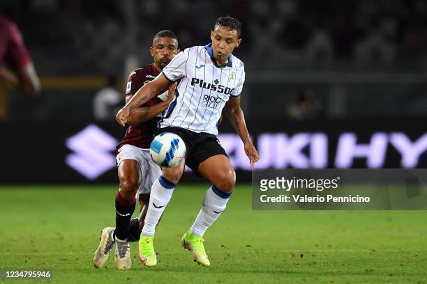 Gleison Bremer of Torino FC competes with Luis Muriel of Atalanta BC during the Serie A match between Torino FC and Atalanta BC at Stadio Olimpico di...
