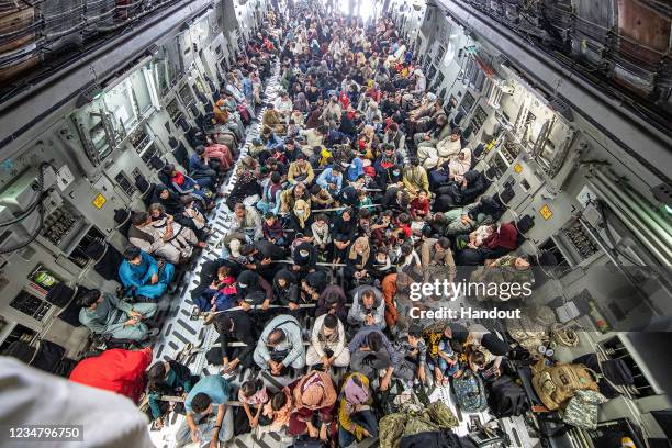 In this handout image provided by the Ministry of Defence, a full flight of 265 people are evacuated out of Kabul by the UK Armed Forces on August...
