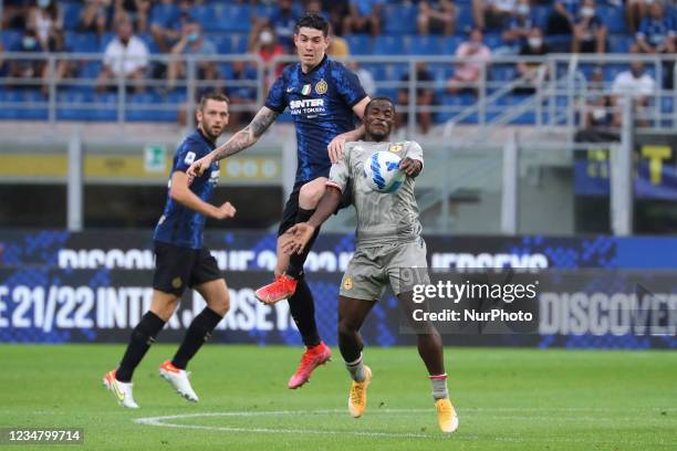Alessandro Bastioni of FC Internazionale competes for the ball with Yayah Kallon of Genoa CFC during the Serie A match between FC Internazionale v...