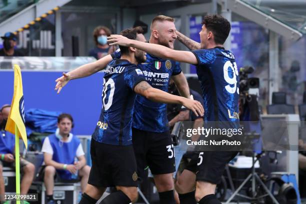 Milan Skriniar of FC Internazionale celebrates with Hakan Calhanoglu and Alessandro Bastioni after scoring the opening goal during the Serie A match...