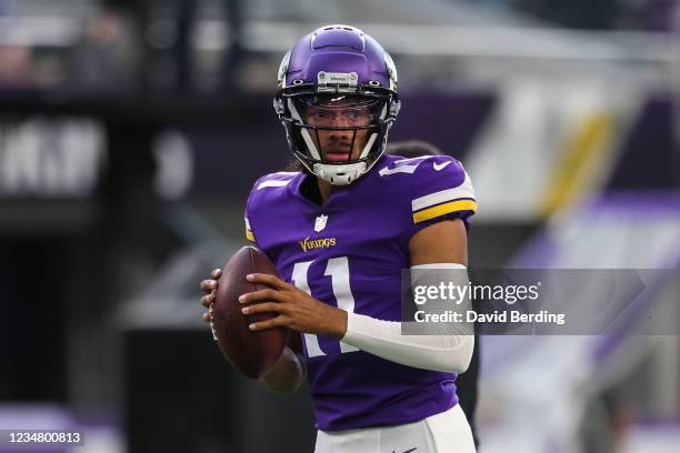 Kellen Mond of the Minnesota Vikings participates in warmups before the start of a preseason game against the Indianapolis Colts at U.S. Bank Stadium...