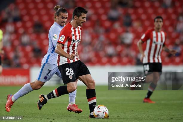 Dani Vivian of Athletic and Antoine Griezmann of Barcelona compete for the ball during the La Liga Santander match between Athletic Club and FC...