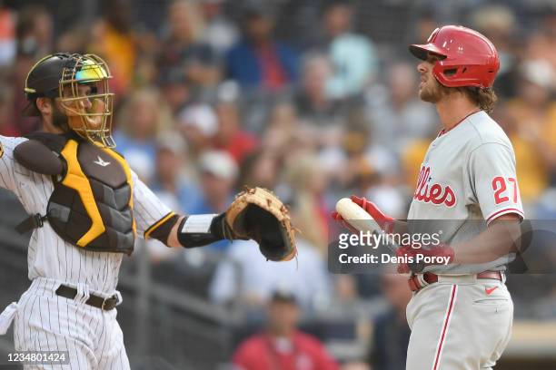Aaron Nola of the Philadelphia Phillies bats as Austin Nola of the San Diego Padres looks on during the second inning of a baseball game at Petco...