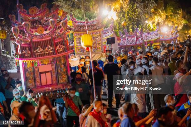 Pilgrims prepare water lanterns during the Hungry Ghost Festival on August 21, 2021 in Keelung, Taiwan. The lanterns are placed in the water and lit...