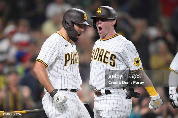 Jake Cronenworth of the San Diego Padres celebrates with Eric Hosmer after hitting a two-run home run during the ninth inning of a baseball game at...