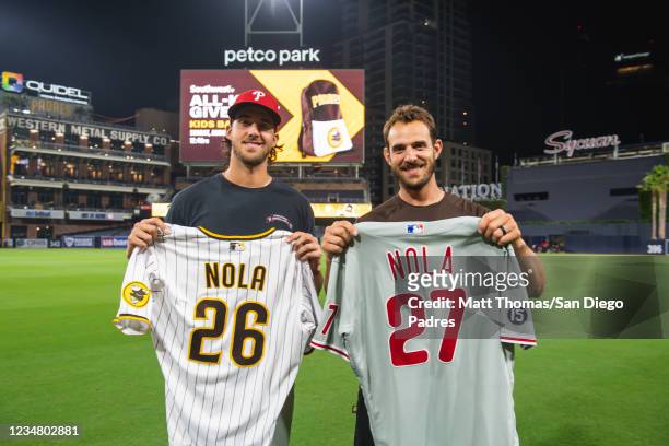 Austin Nola of the San Diego Padres swaps jerseys with his brother Aaron Nola of the Philadelphia Phillies on August 21, 2021 at Petco Park in San...