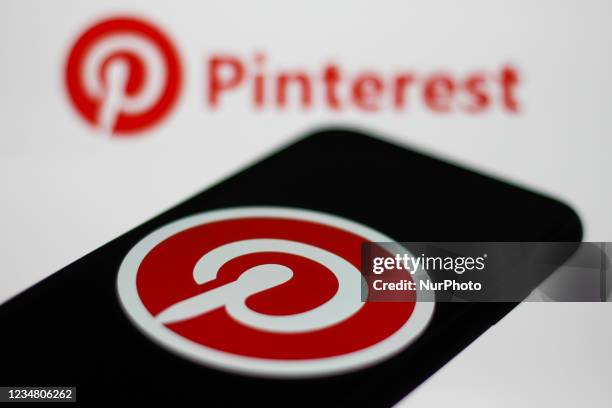 Pinterest logos displayed on a phone and a laptop screens are seen in this illustration photo taken in Krakow, Poland on August 20, 2021.