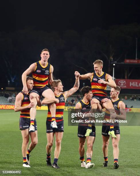 Crows players Tom Lynch and David Mackay who are leaving the club are chaired off the ground by Rory Sloane, Brodie Smith, Lachlan Murphy and Rory...