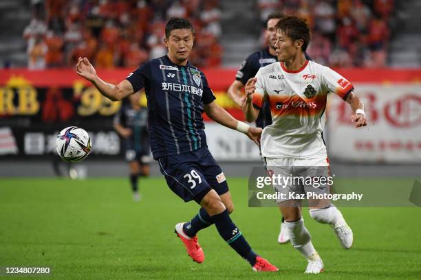 Yoichiro Kakitani of Nagoya Grampus and Tatsuki Nara of Avispa Fukuoka compete for the ball during the J.League Meiji Yasuda J1 match between Nagoya...