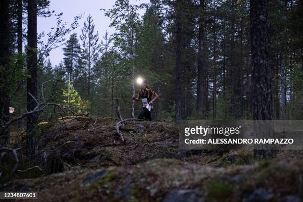 Participant of the Arctic Circle Jukola orienteering run is seen in the woods on early August 22, 2021 in Rovaniemi, Finland. - According to the...