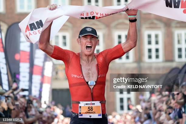 Australian Cameron Wurf celebrates winning the Ironman Copenhagen at Amager Strandpark in Copenhagen, Denmark, on August 22, 2021. - 2500...