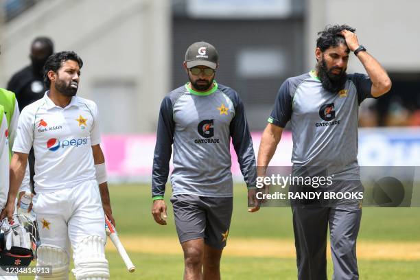 Misbah-ul-Haq Khan Niazi , Mohammad Rizwan and Babar Azam of Pakistan walk off the field after play was suspended during day 3 of the 2nd Test...