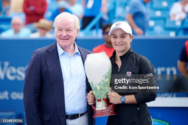 Ashleigh Barty of Australia holds the Rookwood Cup with Chairman, President, and CEO John Barrett of Western & Southern Finacial Group after winning...