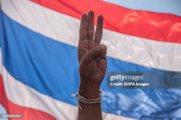 Protester makes the three finger salute during the demonstration. Anti-government protesters gathered at the Democracy monument demanding for...