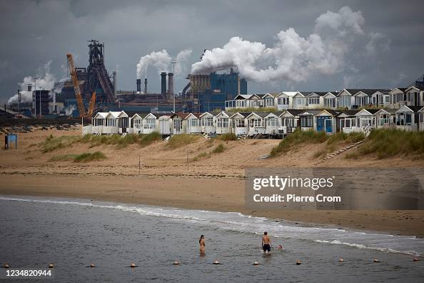 People enjoy the beach of Ijmuiden near the Tata Steel plant on News  Photo - Getty Images