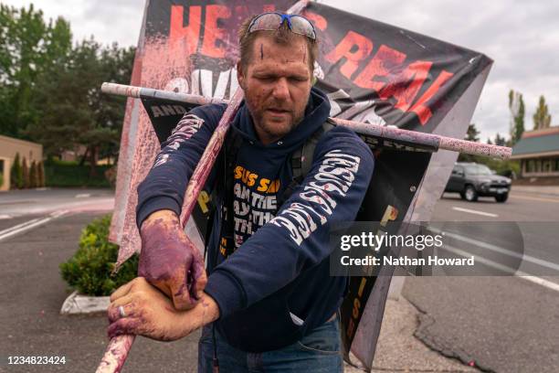 Street preacher reacts after being pepper-sprayed during a fight between the far-right group Proud Boys and far-left activists on August 22, 2021 in...