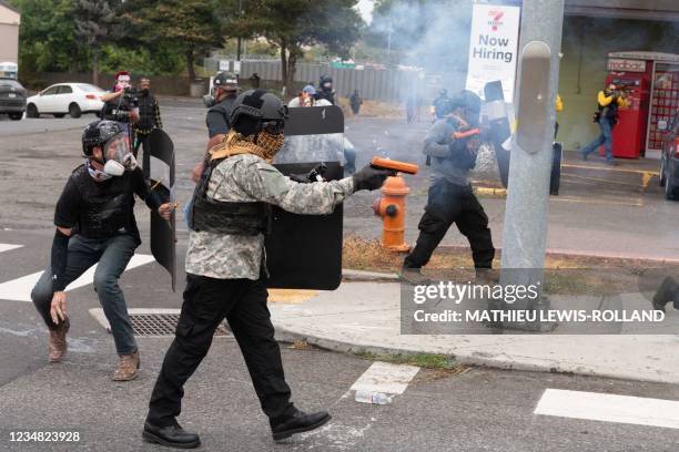 Members of the Proud Boys clash with anti-fascist activists during a far-right rally on August 22, 2021 in Portland, Oregon. - Far-right groups,...