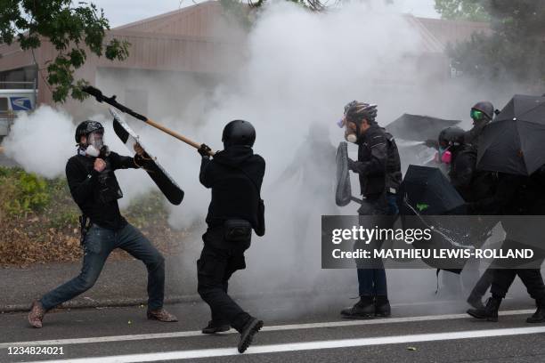 Members of the Proud Boys clash with anti-fascist activists following a far-right rally on August 22, 2021 in Portland, Oregon. - Far-right groups,...