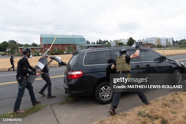 Members of the Proud Boys attack a van during a clash with anti-fascist activists following a far-right rally on August 22, 2021 in Portland, Oregon....