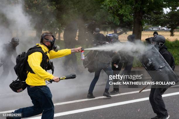 Members of the Proud Boys clash with anti-fascist activists following a far-right rally on August 22, 2021 in Portland, Oregon. - Far-right groups,...