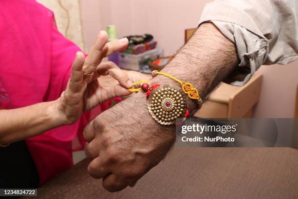 Afghan origin Indian resident show rakhi during a ceremony to celebrate the Raksha Bandhan festival in Kolkata on August 22, 2021.