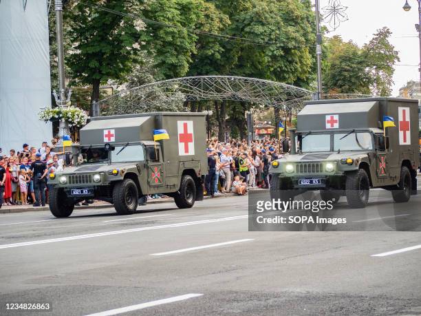 Ukrainian military ambulance vehicles drive in formation during the rehearsal of the military parade which will take place on the Independence Day.
