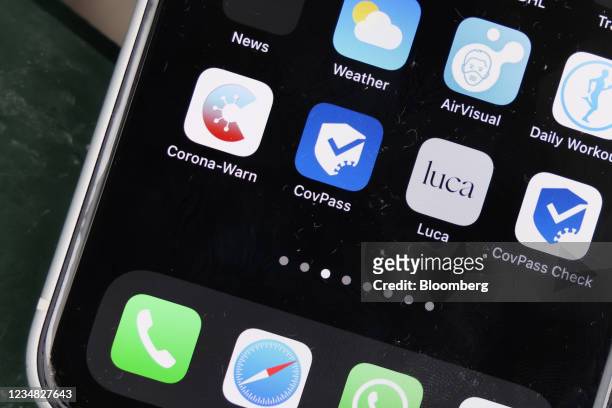 Icons for the Corona-Warn app, the CovPass app, the Luca app and the CovPass Check app on an iPhone arranged in Berlin, Germany, on Monday, Aug. 23,...