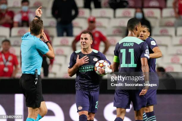 Referee Felix Brych, Mario Gotze of PSV during the UEFA Champions League match between Benfica v PSV at the Estadio La Luz on August 18, 2021 in...