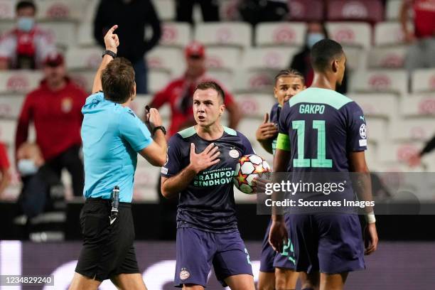 Referee Felix Brych, Mario Gotze of PSV during the UEFA Champions League match between Benfica v PSV at the Estadio La Luz on August 18, 2021 in...