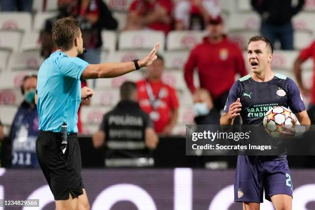 Referee Felix Brych, Mario Gotze of PSV during the UEFA Champions League match between Benfica v PSV at the Estadio La Luz on August 18, 2021 in...