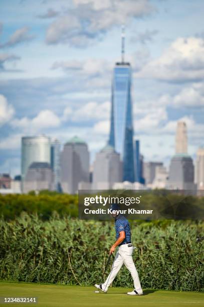 Abraham Ancer of Mexico reacts as his birdie putt rolls in on the 14th hole green in front of the New York City skyline during the first round of THE...