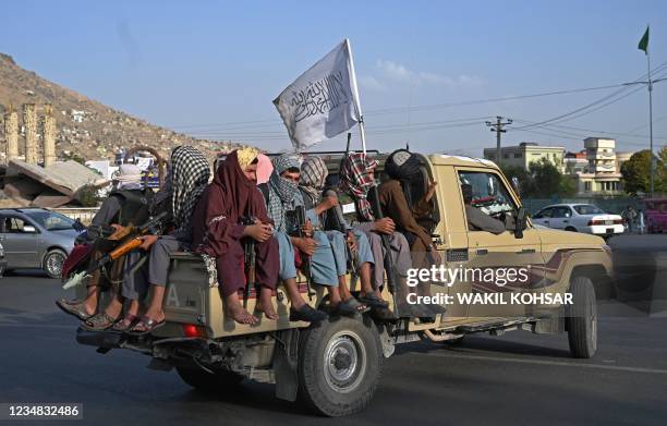 Taliban fighters in a vehicle patrol the streets of Kabul on August 23, 2021 as in the capital, the Taliban have enforced some sense of calm in a...