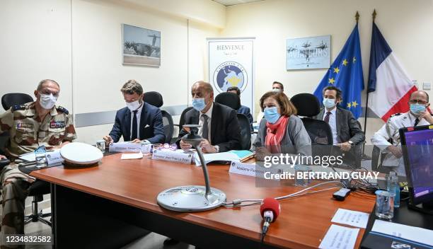 French Defence Minister Florence Parly and French Foreign Minister Jean-Yves Le Drian take part in a video meeting with Kabul and the crisis and...