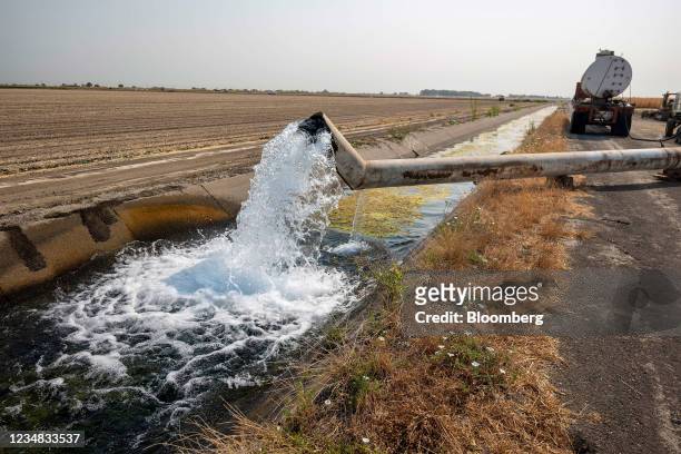 Water is pumped from a well into an irrigation canal on a farm in Yolo County, California, U.S., on Wednesday, Aug. 11, 2021. The drought is so...