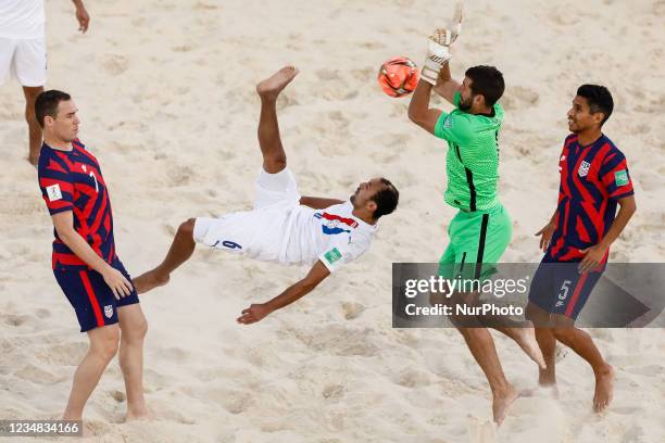 Pedro Moran of Paraguay performs a bicycle kick as Nick Perera , Chris Toth and Nicolas Perea of USA defend during the FIFA Beach Soccer World Cup...