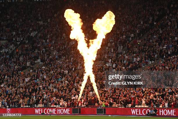 Fire display and 'Welcome Home' signs greet West Ham fans as they take their seats ahead of the English Premier League football match between West...