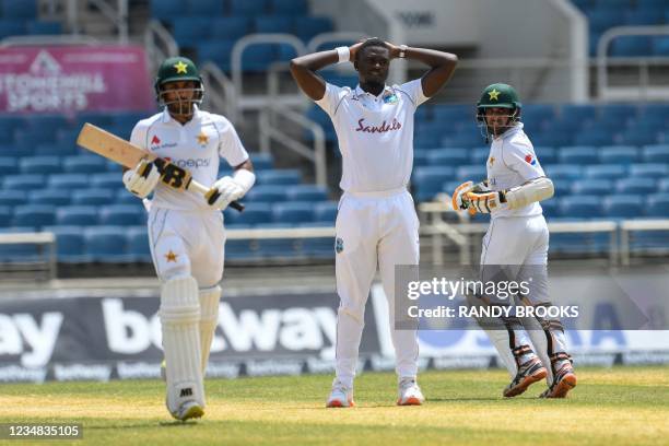 Jayden Seales of West Indies expresses disappointment as Abid Ali and Imran Butt of Pakistan run during day 4 of the 2nd Test between West Indies and...