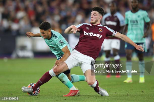 Declan Rice of West Ham United tackles Ayoze Perez of Leicester City during the Premier League match between West Ham United and Leicester City at...