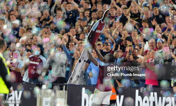 Michail Antonio of West Ham United celebrates with a cardboard cut out of himself after scoring to make it 4-1 during the Premier League match...