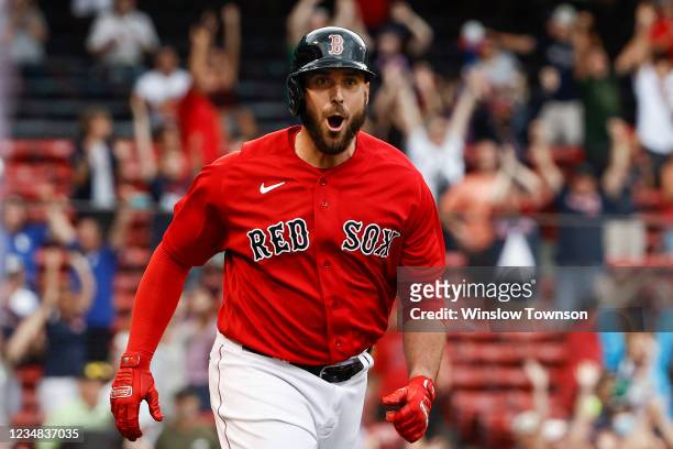 Travis Shaw of the Boston Red Sox shouts out to teammates as he rounds the bases after his game-winning grand slam home run against the Texas Rangers...