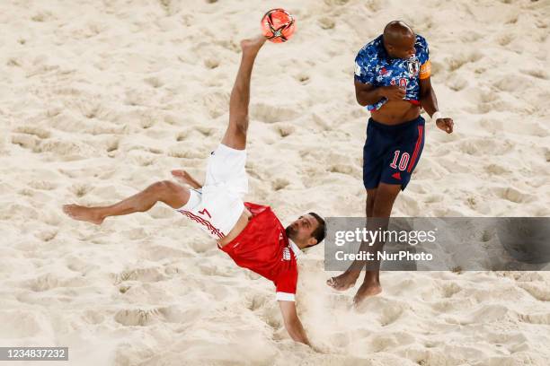 Aleksey Makarov of Football Union Of Russia performs a bicycle kick as Ozu Moreira of Japan defends during the FIFA Beach Soccer World Cup Russia...