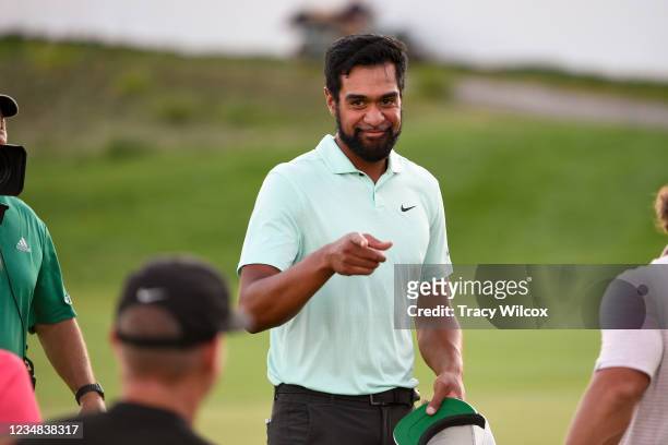 Tony Finau points to his coach, Boyd Summerhays after winning in a playoff during the weather delayed final round of THE NORTHERN TRUST at Liberty...