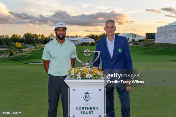 Tony Finau poses with Michael O’Grady the CEO of Northern Trust during the trophy ceremony in the weather delayed final round of THE NORTHERN TRUST...